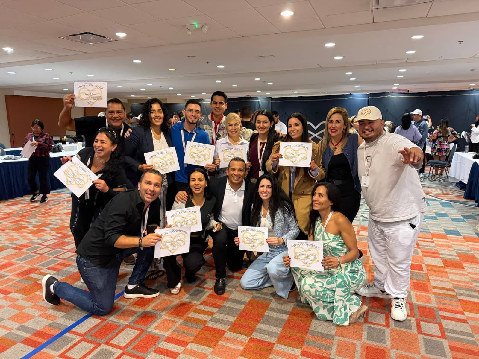 Jairo J. García with graduates of the Conscious Love Coaching certification showing their certificates