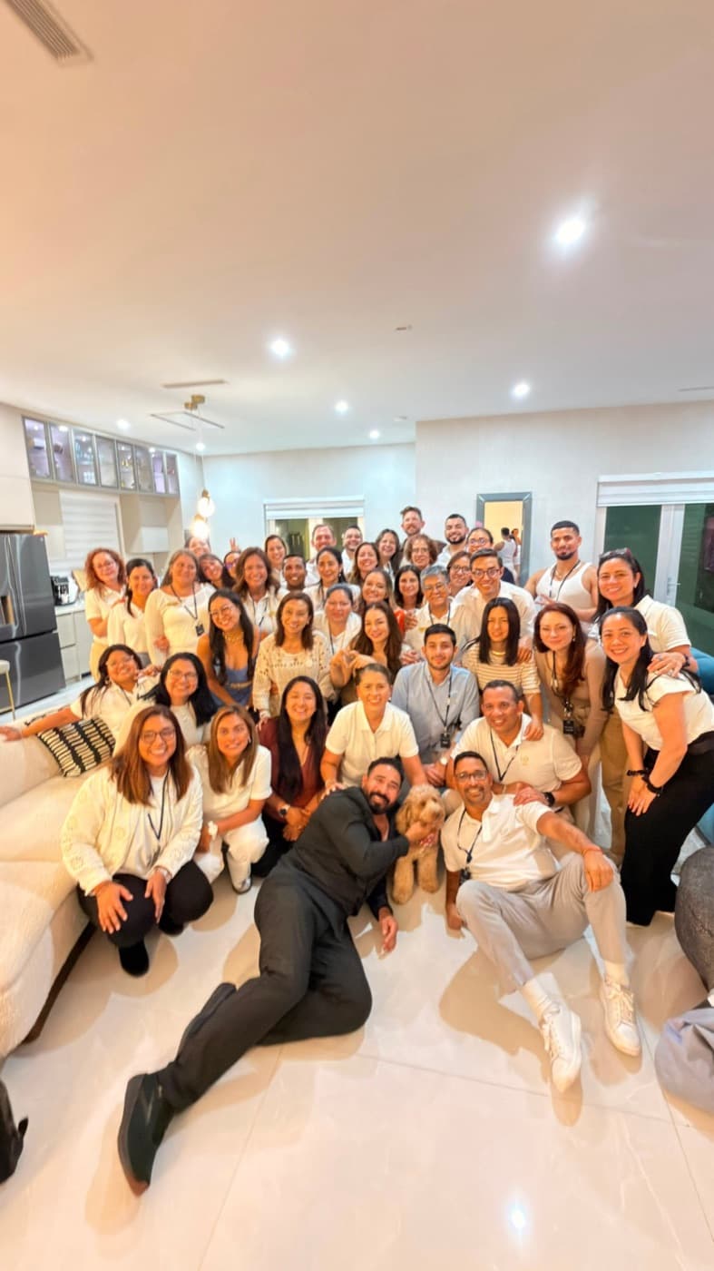 A large group of participants dressed in white gathered at a community meetup
